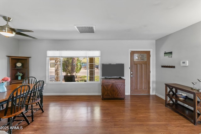 interior space with baseboards, wood finished floors, and visible vents