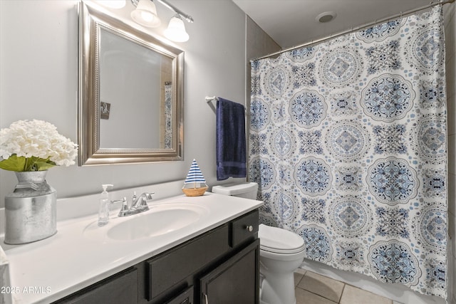 bathroom with toilet, a shower with shower curtain, vanity, and tile patterned floors