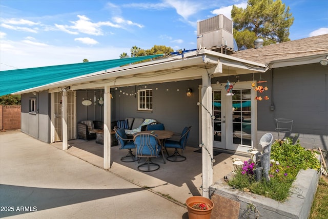 back of property featuring central AC, french doors, a patio, an outdoor living space, and metal roof
