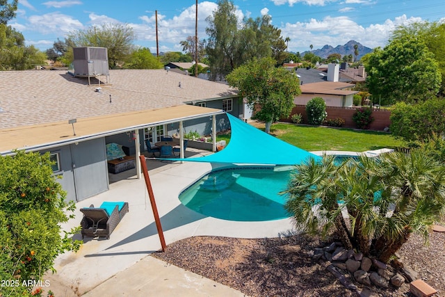 view of pool with a fenced in pool, a fenced backyard, central AC unit, a patio area, and a yard