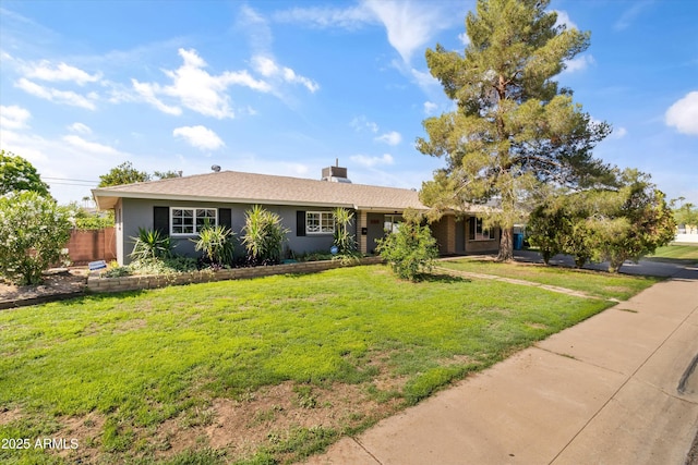 ranch-style home with a chimney, a front lawn, and fence