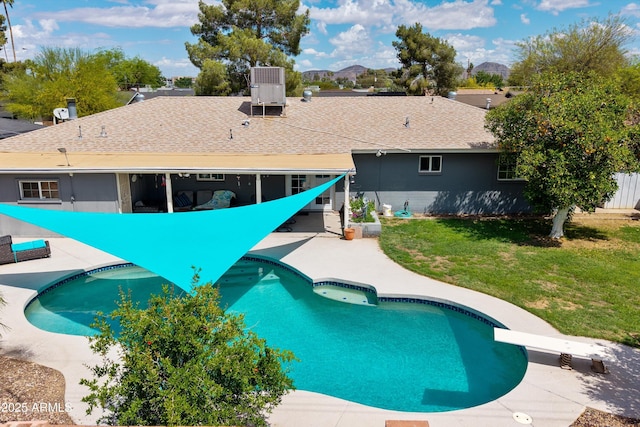 outdoor pool featuring cooling unit, a yard, a patio area, and fence