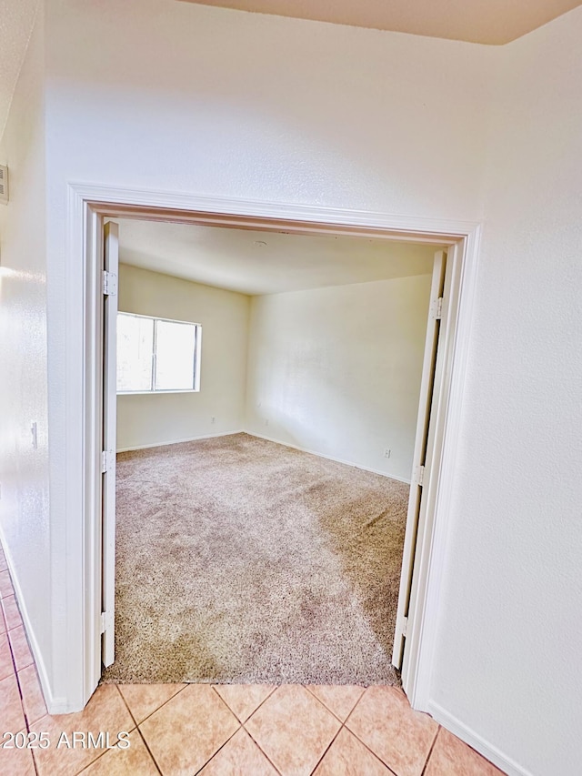 spare room featuring light colored carpet