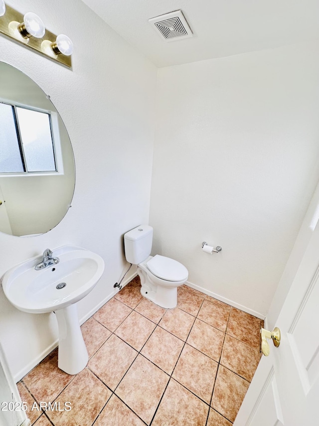 bathroom featuring tile patterned flooring and toilet