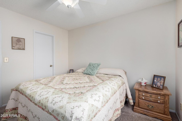 carpeted bedroom featuring ceiling fan and a textured ceiling