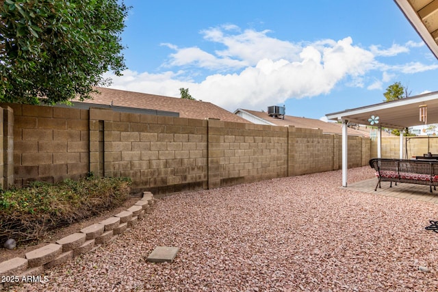 view of yard with cooling unit and a patio