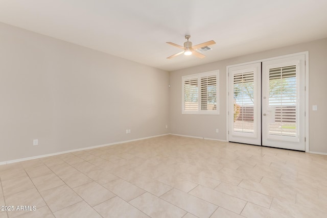 spare room featuring ceiling fan and light tile patterned floors