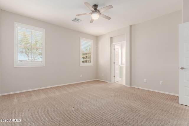 unfurnished room with ceiling fan and light colored carpet