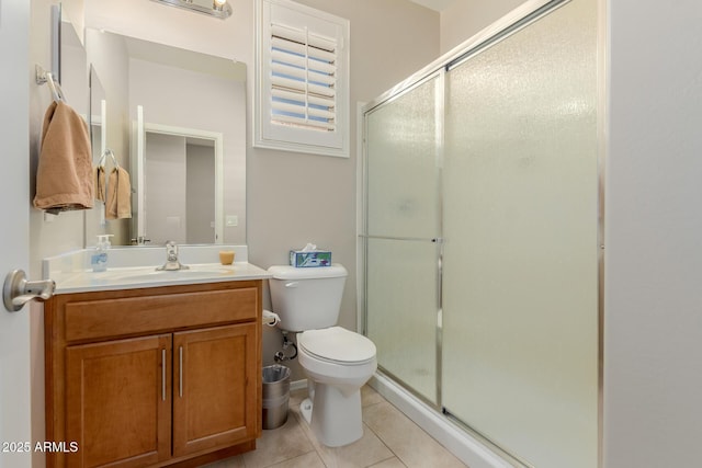 bathroom with vanity, tile patterned flooring, a shower with shower door, and toilet