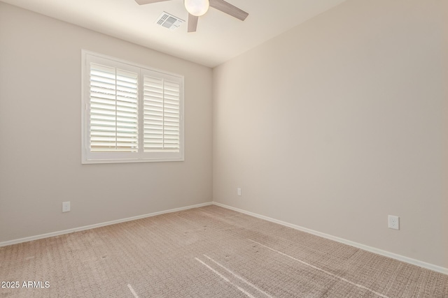 carpeted spare room with ceiling fan