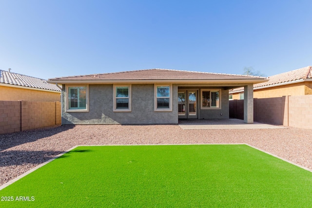 rear view of property featuring a patio area