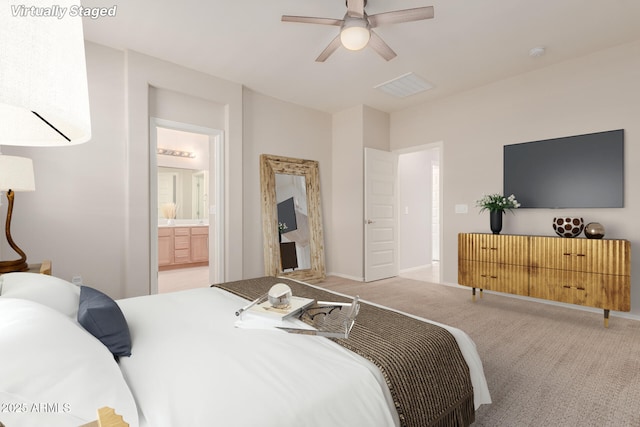 carpeted bedroom with ceiling fan and connected bathroom