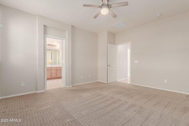 unfurnished bedroom with ensuite bathroom, ceiling fan, and light carpet