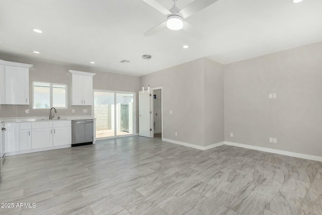 kitchen with recessed lighting, light countertops, white cabinetry, dishwasher, and baseboards