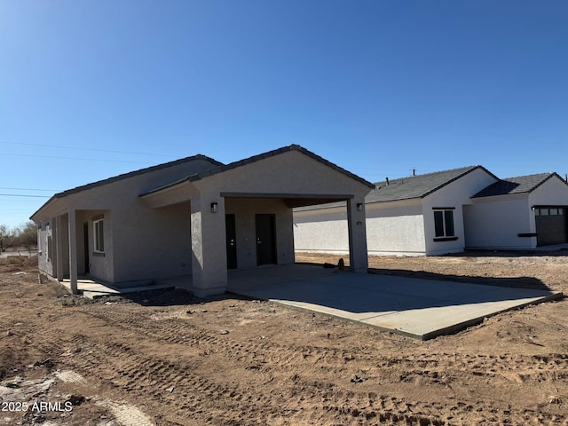 view of front of house featuring concrete driveway and stucco siding