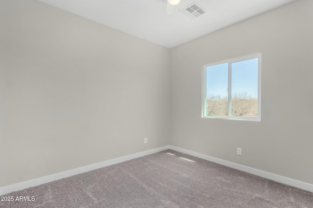 empty room featuring carpet floors, baseboards, and visible vents