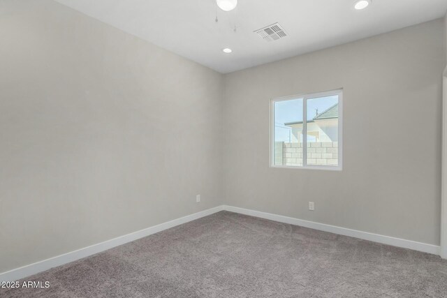 carpeted spare room featuring recessed lighting, visible vents, and baseboards