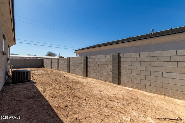 view of yard featuring a fenced backyard and central AC unit