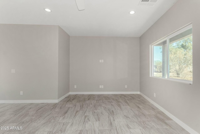 spare room featuring recessed lighting, visible vents, and baseboards