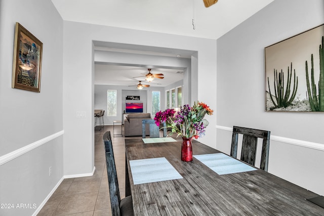 tiled dining space with ceiling fan