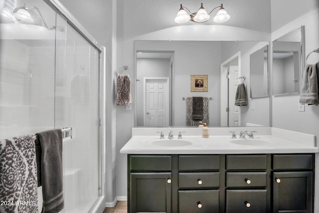 bathroom featuring vanity, tile patterned floors, and a shower with shower door