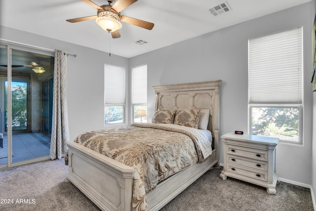 carpeted bedroom with access to outside, multiple windows, and ceiling fan