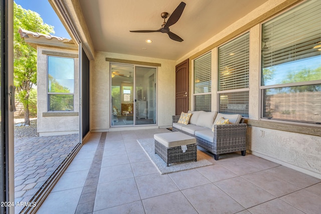 unfurnished sunroom featuring ceiling fan