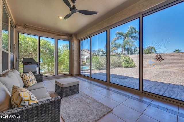 sunroom / solarium featuring ceiling fan