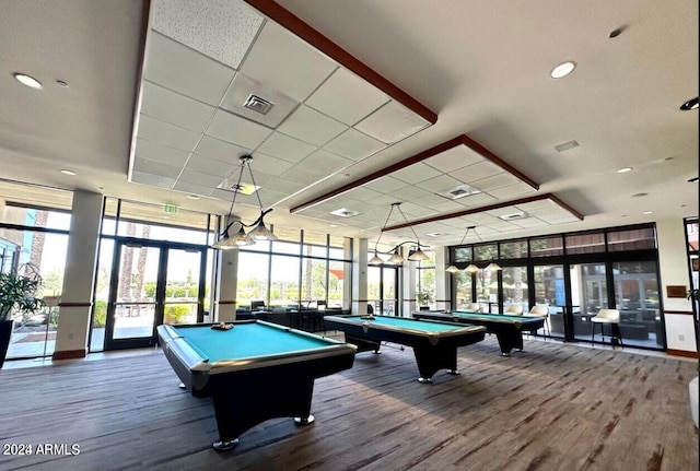 recreation room featuring a wall of windows, hardwood / wood-style flooring, and billiards