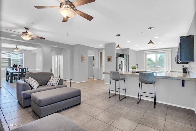 tiled living room with ceiling fan