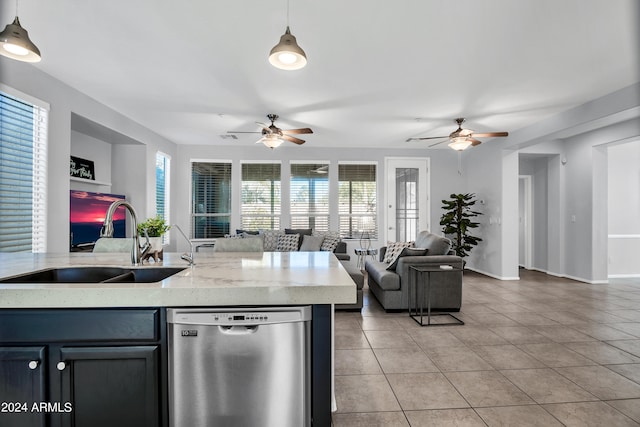 kitchen featuring pendant lighting, dishwasher, sink, and a healthy amount of sunlight