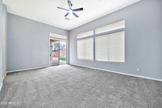 empty room featuring a ceiling fan, carpet flooring, visible vents, and baseboards