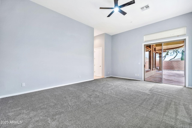 carpeted spare room featuring baseboards, visible vents, and ceiling fan