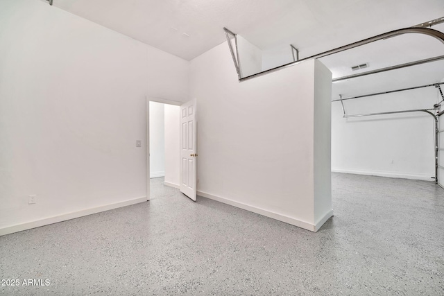 garage with visible vents and baseboards