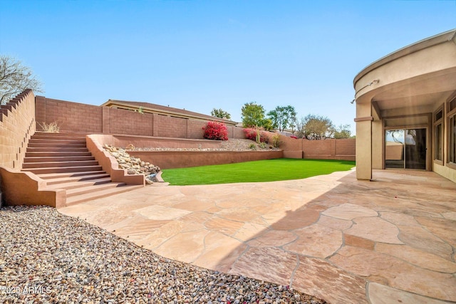 view of patio featuring a fenced backyard and stairs