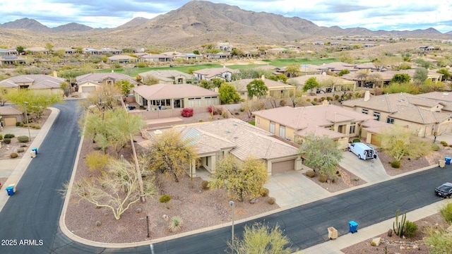 drone / aerial view featuring a residential view and a mountain view