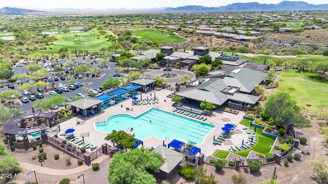 birds eye view of property with golf course view and a mountain view