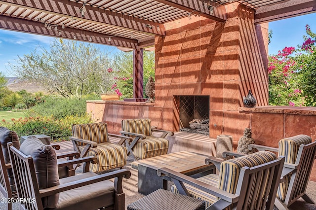 view of patio with an outdoor living space with a fireplace and a pergola