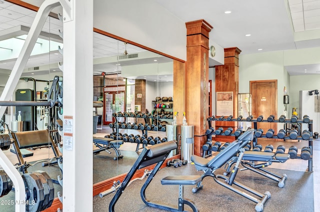 exercise room with a paneled ceiling, visible vents, and recessed lighting