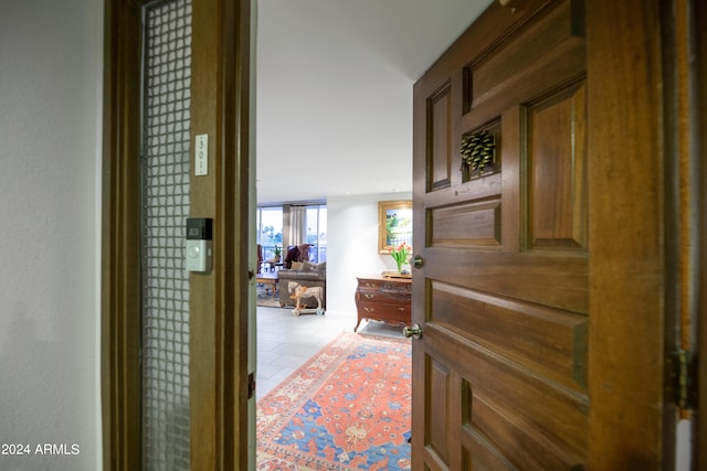 corridor with light tile patterned floors