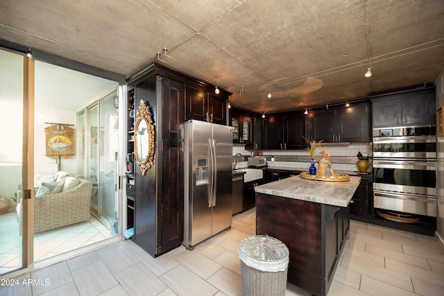 kitchen featuring dark brown cabinets, a center island, and appliances with stainless steel finishes