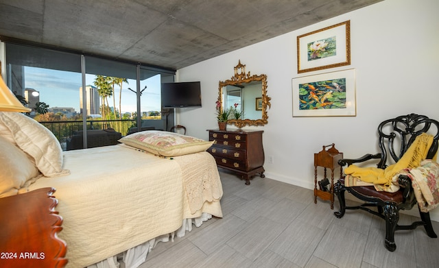 bedroom featuring access to exterior and a wall of windows