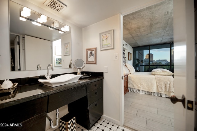 bathroom with expansive windows, vanity, and a healthy amount of sunlight