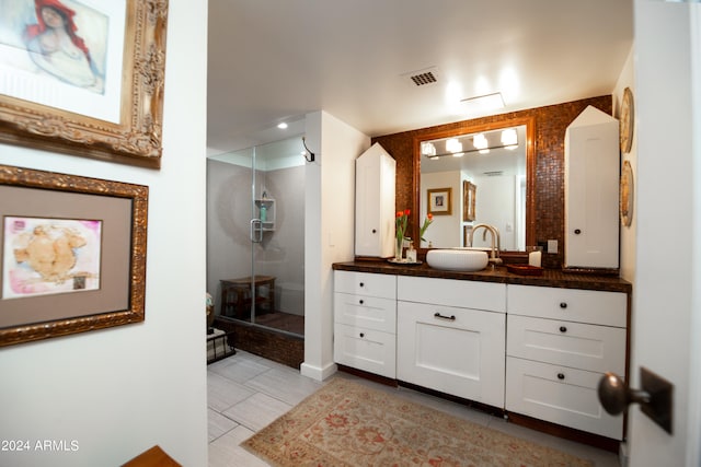 bathroom with tile patterned floors, vanity, an enclosed shower, and toilet