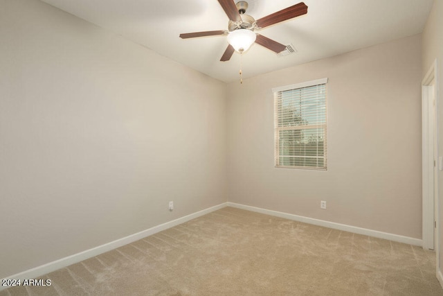 unfurnished room with ceiling fan and light colored carpet