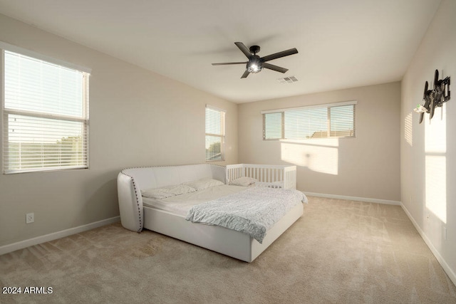 carpeted bedroom with ceiling fan