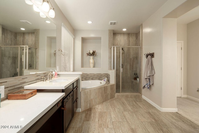 bathroom featuring vanity and separate shower and tub