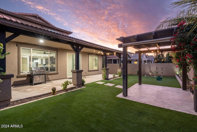 yard at dusk featuring a patio