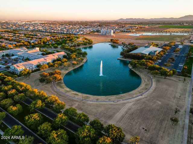 aerial view at dusk featuring a water view