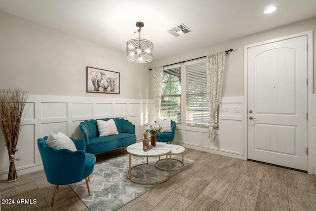 living area featuring an inviting chandelier